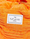 The Flat Lay Co. Drawstring Bag - Orange Towel. ذا فلات لاي كو. حقيبة برباط - منشفة برتقالية - Princess Cosmetics Qatar